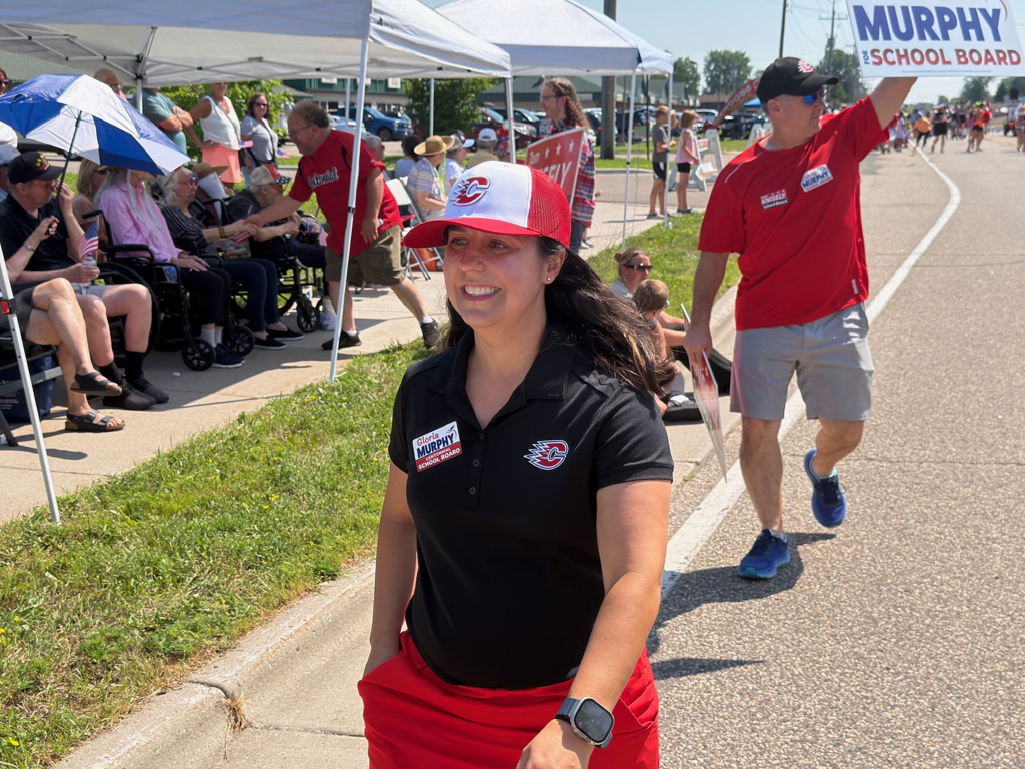 Gloria walking with neighbors at a Centennial community parade